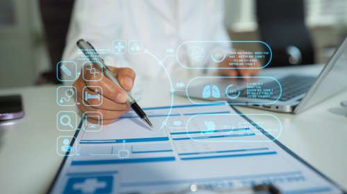 Doctor,Working,On,Laptop,And,Tablet,And,Medical,On,Clipboard