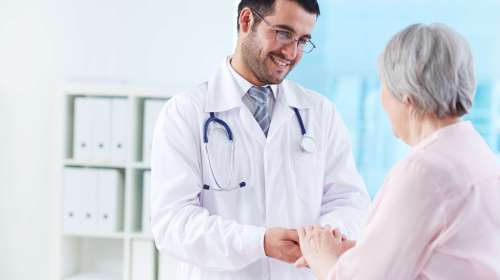 Confident,Doctor,Looking,At,His,Senior,Patient,While,Speaking,To