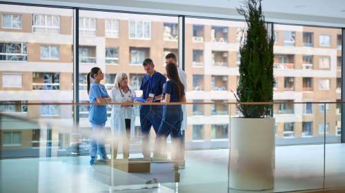 Healthcare,Team,Collaborates,Inside,Bright,Hospital,Building,During,A,Meeting